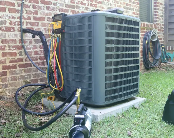ComfortMax HVAC technician servicing an outdoor air conditioning unit in Stockbridge, GA